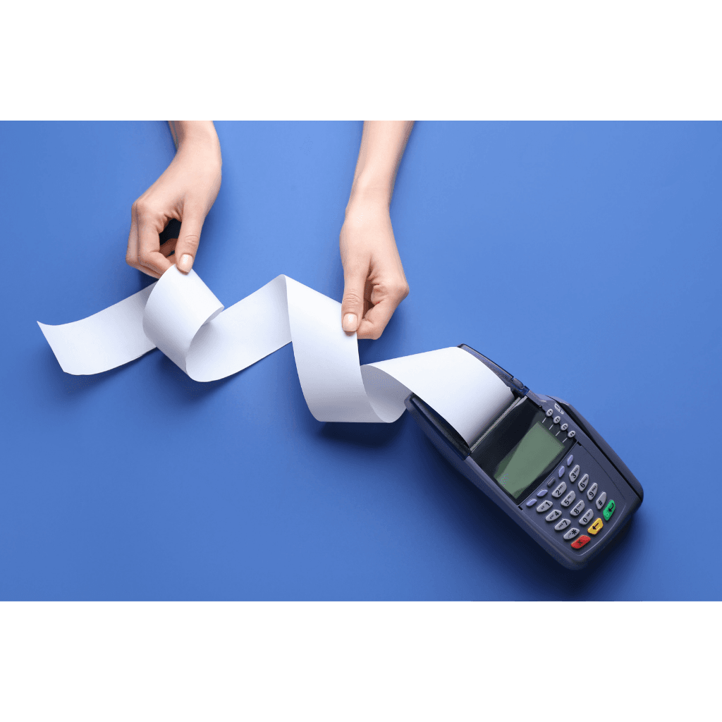 Hands pulling a receipt from a machine to show how invoice factoring works when a business creates an invoice for customer payment.